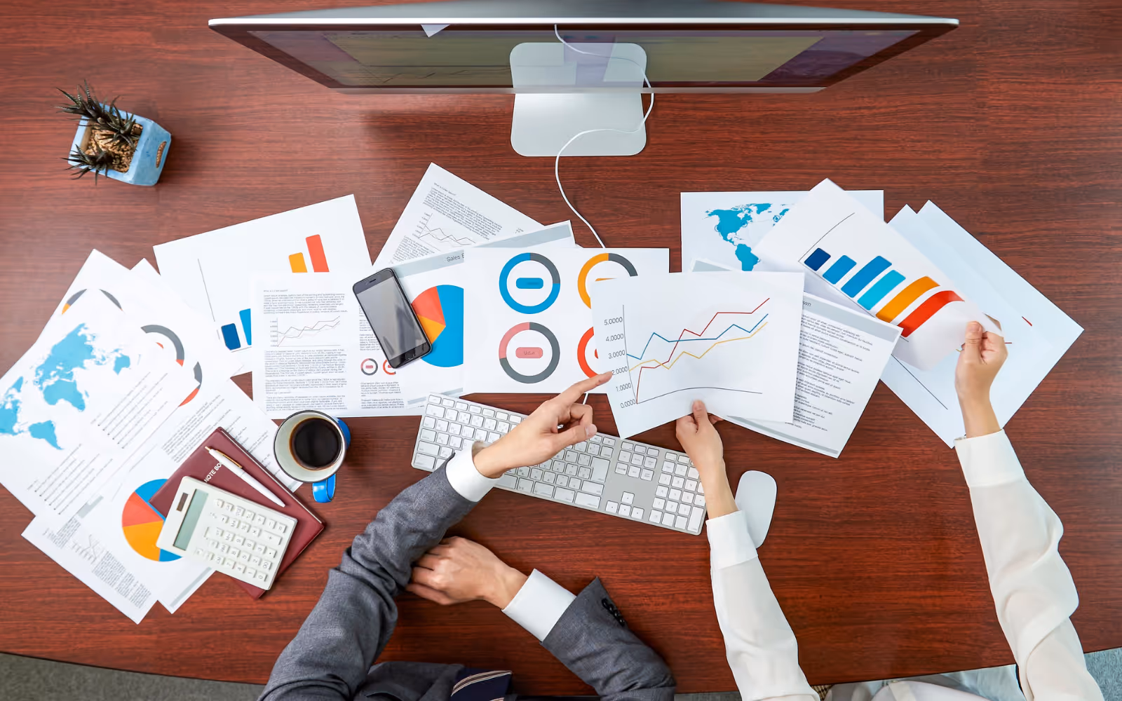 Small business owners analyzing customer loyalty programs ROI with graphs and charts showing growth and retention